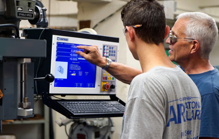 Professor with student in the Machine Shop 768x486