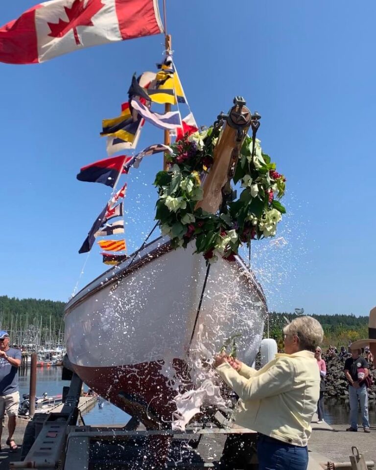 Carol launch with flags 768x961